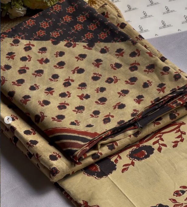 Folded fabric with floral pattern on a gray surface
