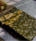 Floral-patterned fabric on a white surface with a blurred background